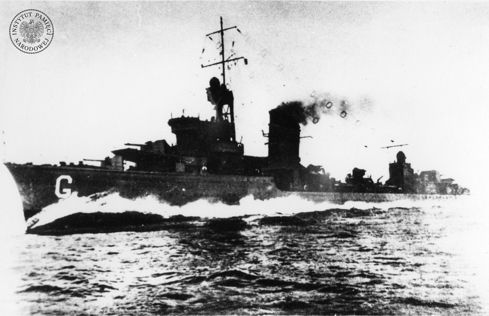 Nowy polski niszczyciel ORP „Grom” podczas marszu na pełnej prędkości w czasie prób stoczniowych – widok lewej burty od strony dziobu. Na dziobie znak taktyczny – wielka biała litera „G”, 1937 r. (fot. z zasobu AIPN)