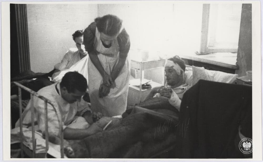 Lekarz i pielęgniarka przy rannym powstańcu, szpital powstańczy IV Zgrupowania Gurt przy ul. Złotej 22 lub 58, ewent. przy ul. Chmielnej 28, fot. Henryk Śmigacz, z zasobu Archiwum IPN, sygn. IPNBU-2-21-32-17-1