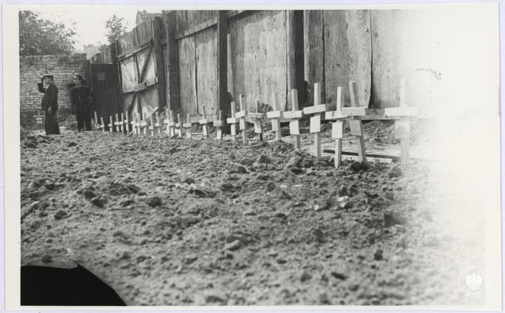 Rząd drewnianych krzyży najprawdopodobniej na zbiorowej mogile na cmentarzu powstańczym w Śródmieściu Północnym, fot. Henryk Śmigacz, z zasobu Archiwum IPN, sygn. IPNBU-2-21-33-1