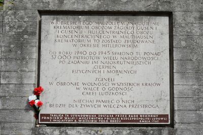 Tablica z okresu PRL na murze Memoriału Gusen. (fot. Maciej Foks)