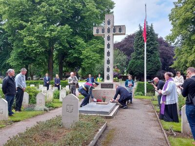 Złożenie kwiatów pod krzyżem na polskim cmentarzu wojennym w Newark-on-Trent, 26 czerwca 2021. Fot. Instytut Kultury Polskiej w Londynie