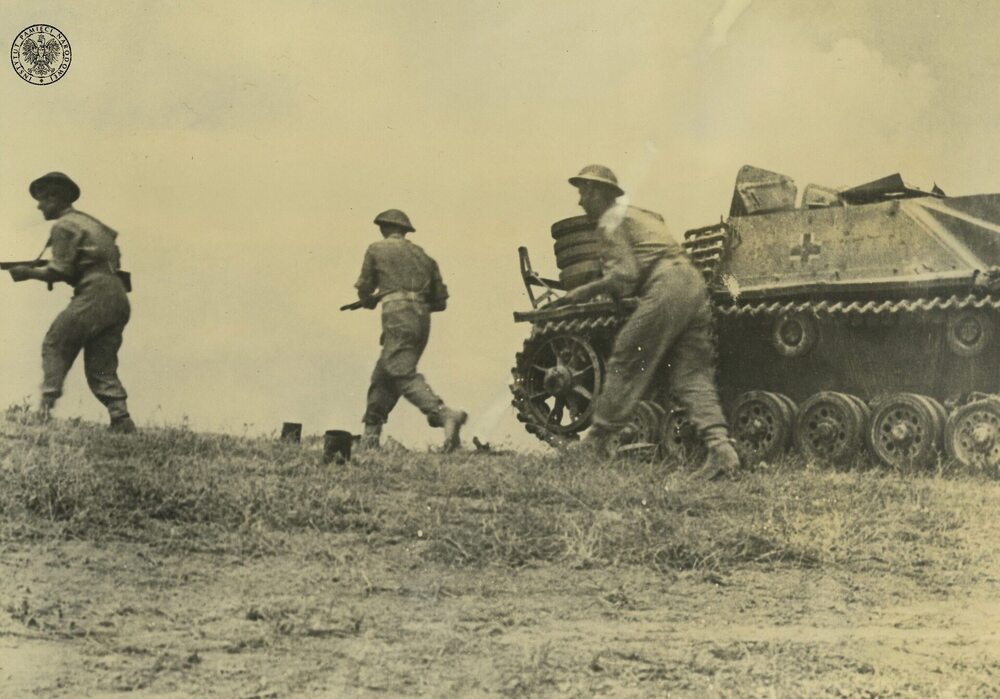 Trzech żołnierzy piechoty z jednego z oddziałów 2. Korpusu Polskiego mijających zniszczone niemieckie działo samobieżne Sturmgeschütz III podczas walk w rejonie Ankony. Odbitka rozpowszechniana przez komórki propagandy rządu RP na uchodźstwie (fot. z zasobu IPN)