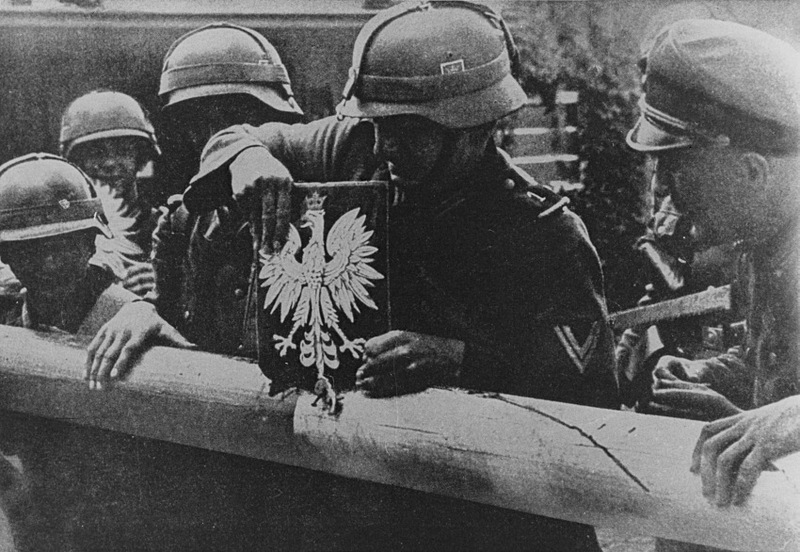 German soldiers breaking Polish border barrier in September 1939